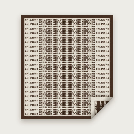 The Heir blanket in Chocolate and bone, laid flat with one corner folded back to show the reverse