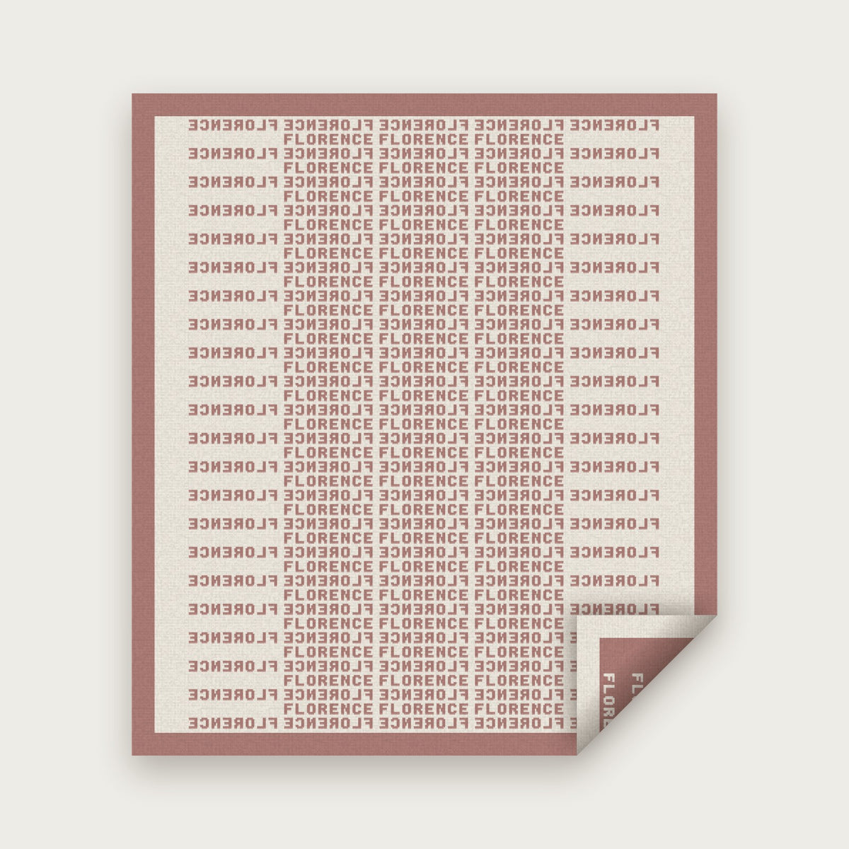 The Heir blanket in Rose and bone, laid flat with one corner folded back to show the reverse