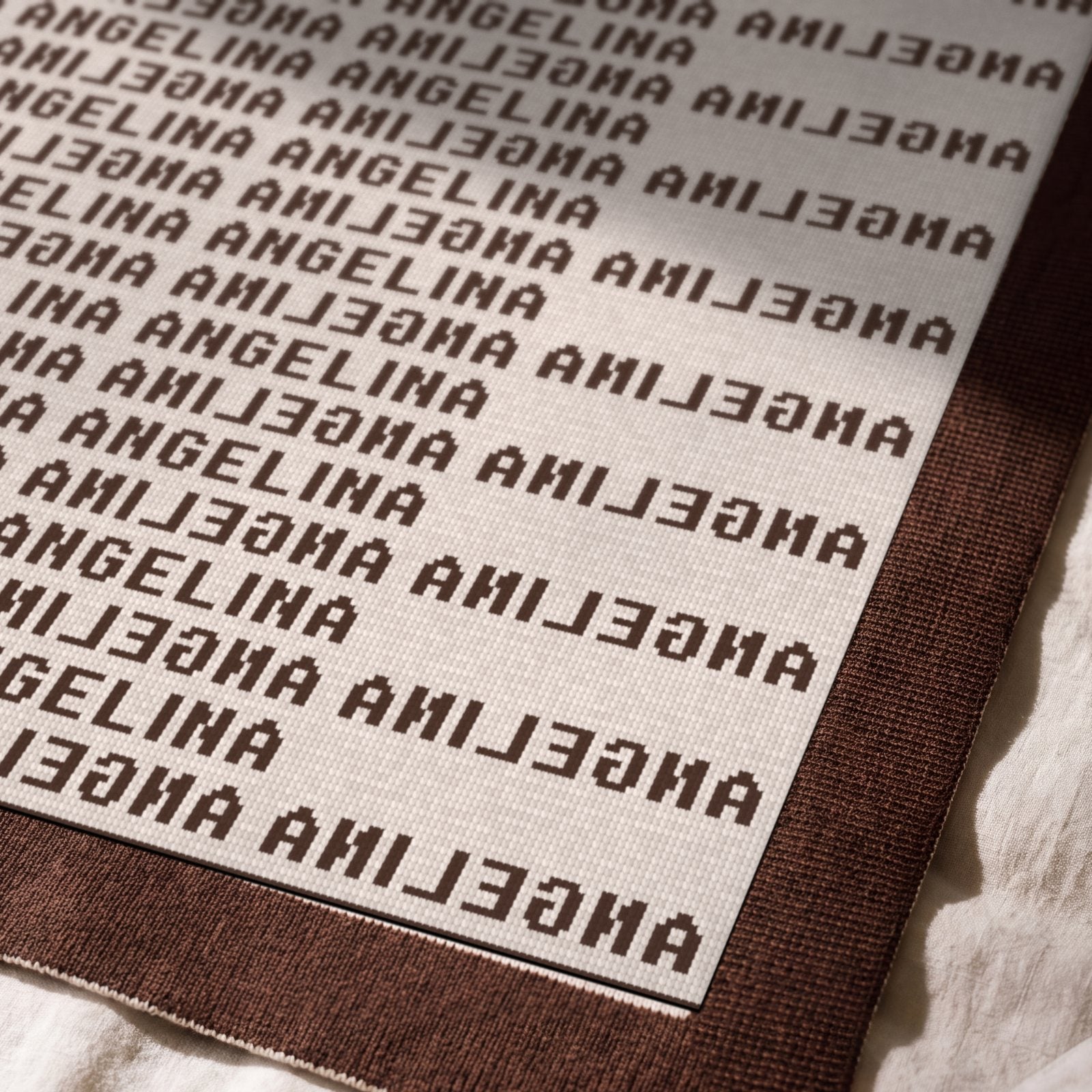 Close view across the knit and the solid chocolate border in side light
