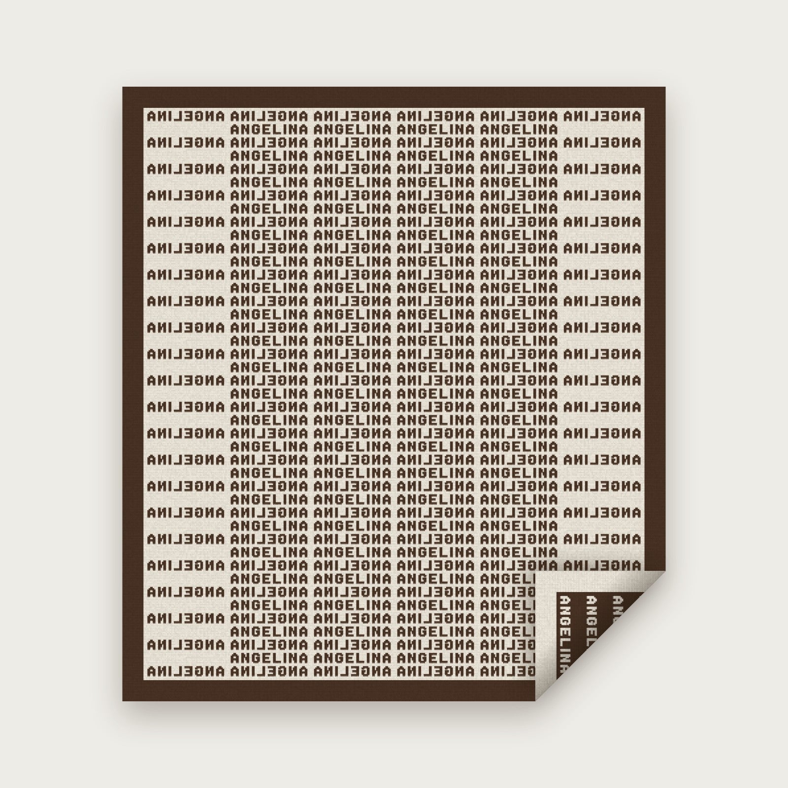 A Heir blanket for Angelina in chocolate on bone, laid flat with one corner folded back